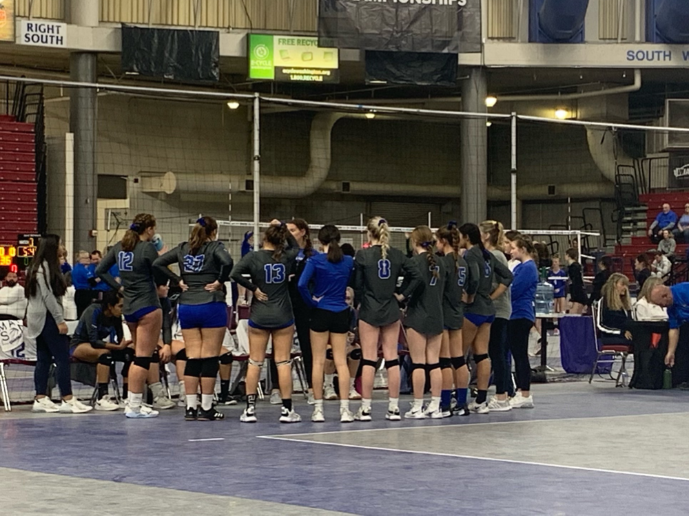 The Manson volleyball team huddles at the State Tournament.
